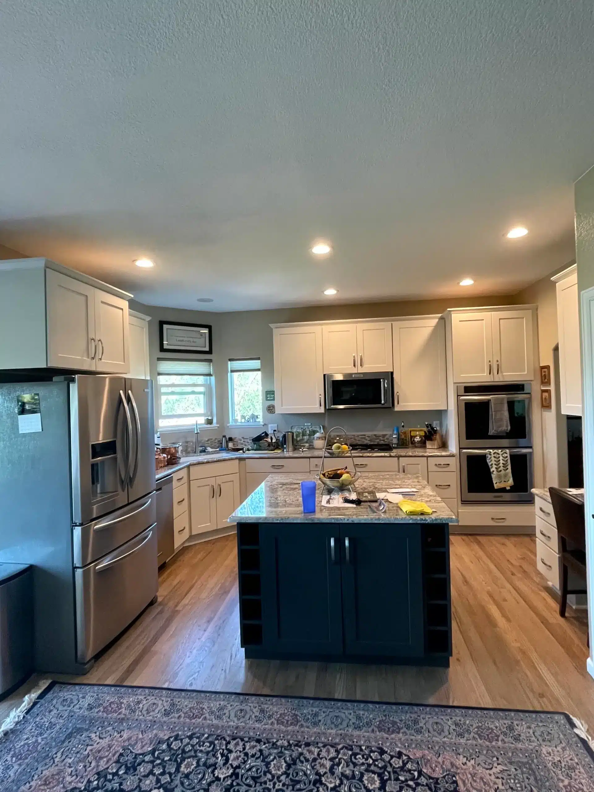 Kitchen with repainted gray cabinets and stainless fridge in Colorado