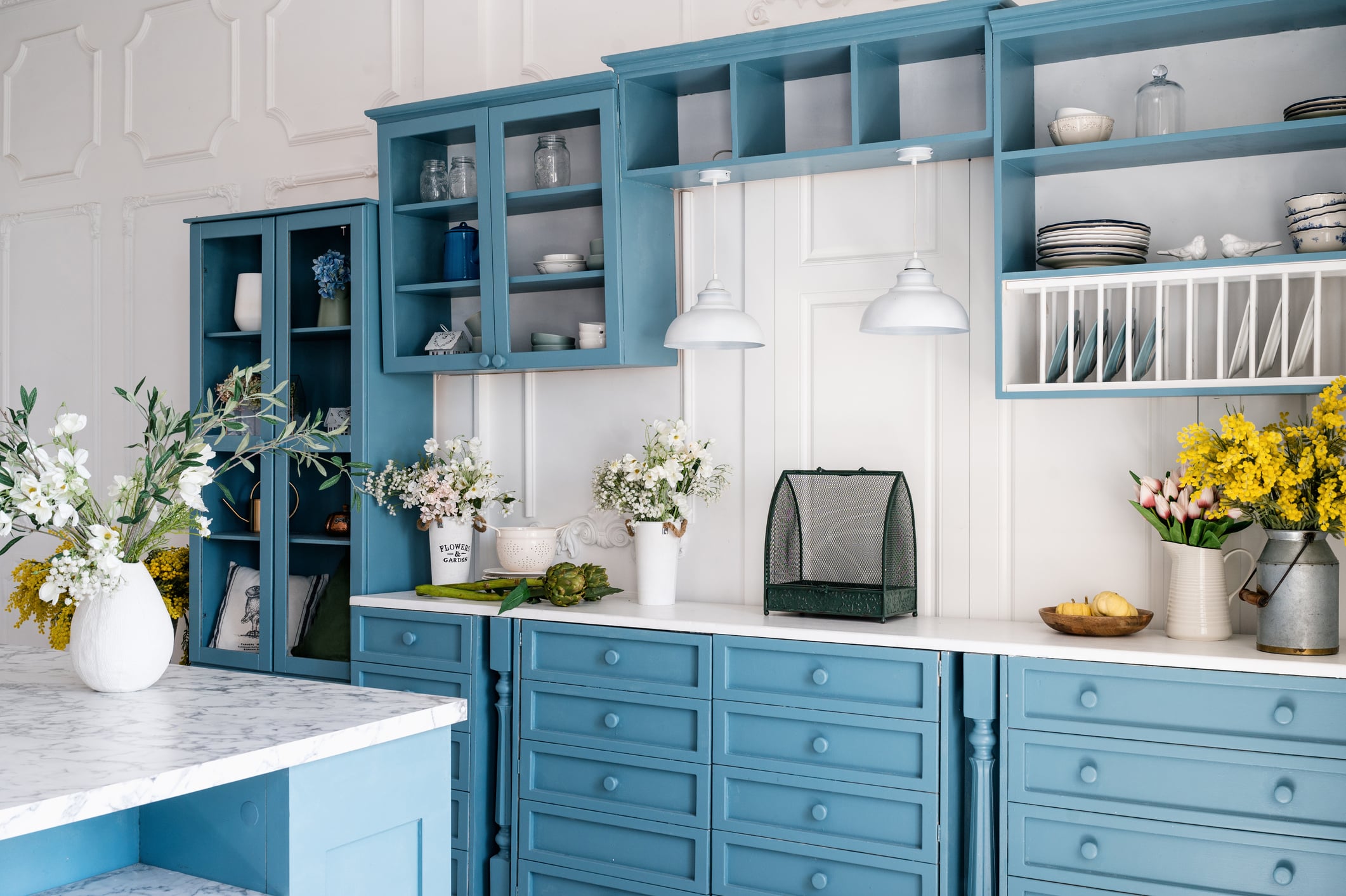 Kitchen with blue vintage furniture and white walls
